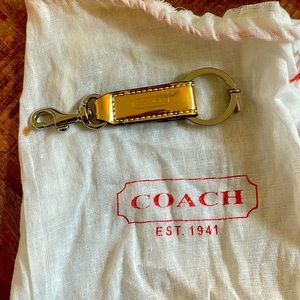 Gold coach keychain with little dust bag
